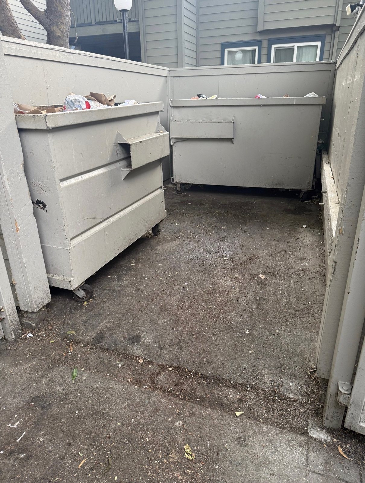 Services Dumpster enclosure cleared and swept after a junk removal cleanout in Elk Grove, CA
