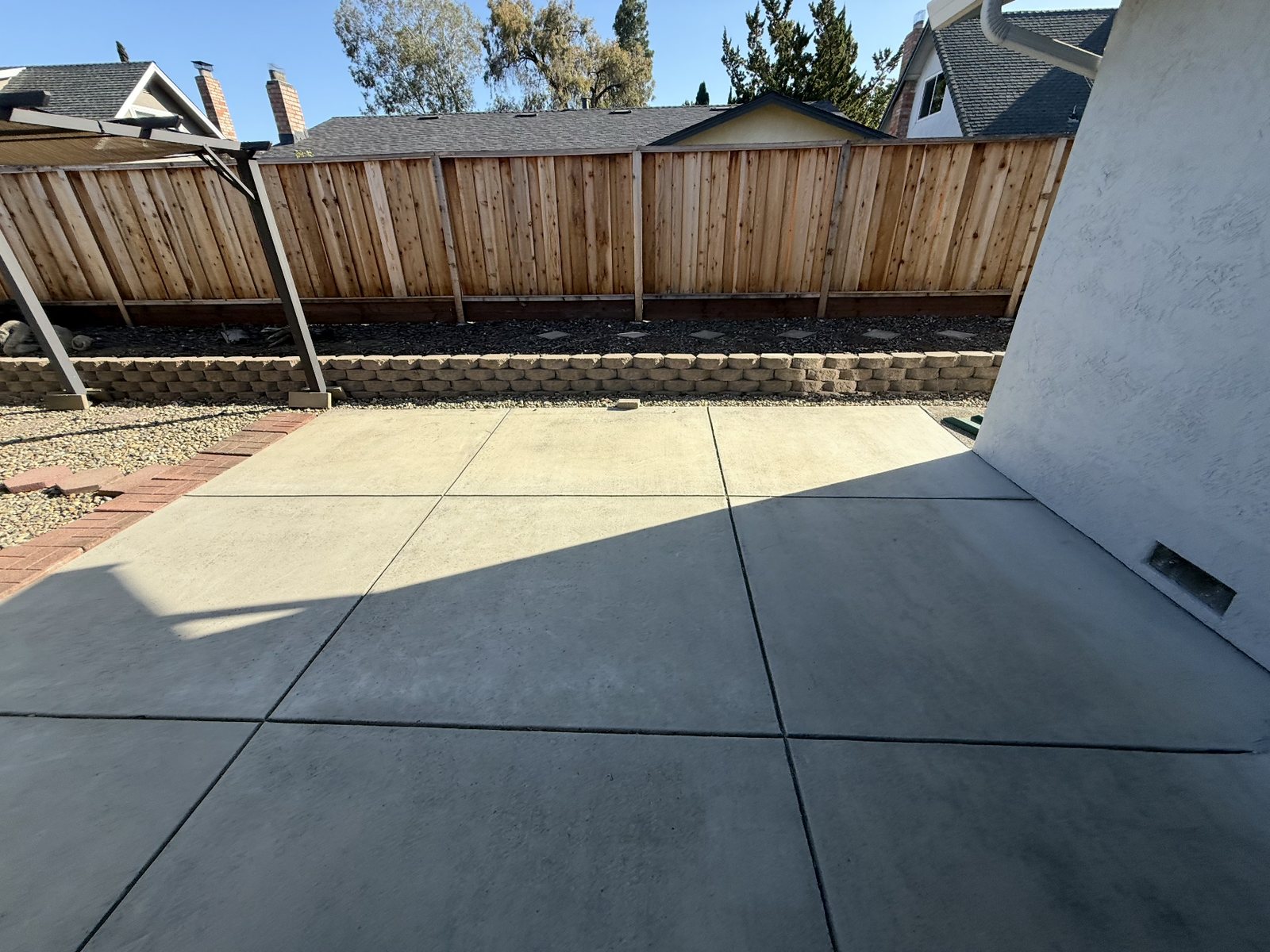 The same Elk Grove back patio swept clean and empty after the junk removal crew finished